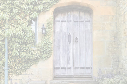 Faded, muted view of a weathered wooden double door on a stone building, surrounded by ivy and delicate flowers.