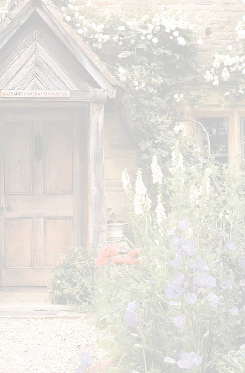 Muted, soft view of a rustic wooden door of a charming stone cottage with a small porch and blooming garden flowers.