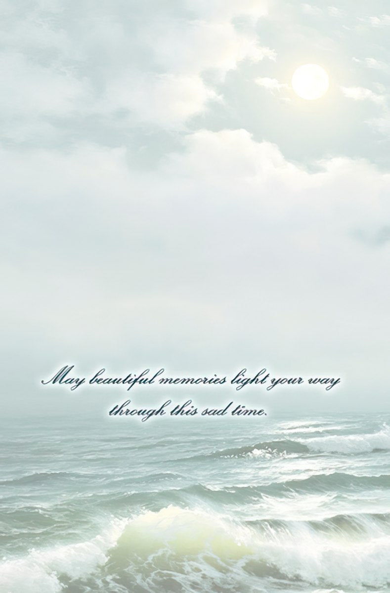 The inside of a sympathy card with a serene ocean and sky background, bearing the message: 'May beautiful memories light your way through this sad time.'