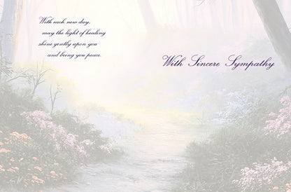 The inside of a sympathy card with a misty forest path background and 'With each new day, may the light of healing shine gently upon you'.