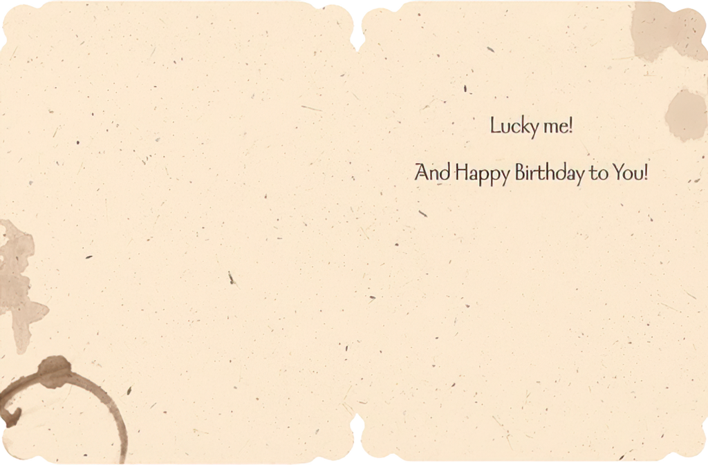 Inside of a rustic-themed birthday greeting card with coffee stain designs. Text says: 'Lucky me! And Happy Birthday to You!' showing space for a personal message.