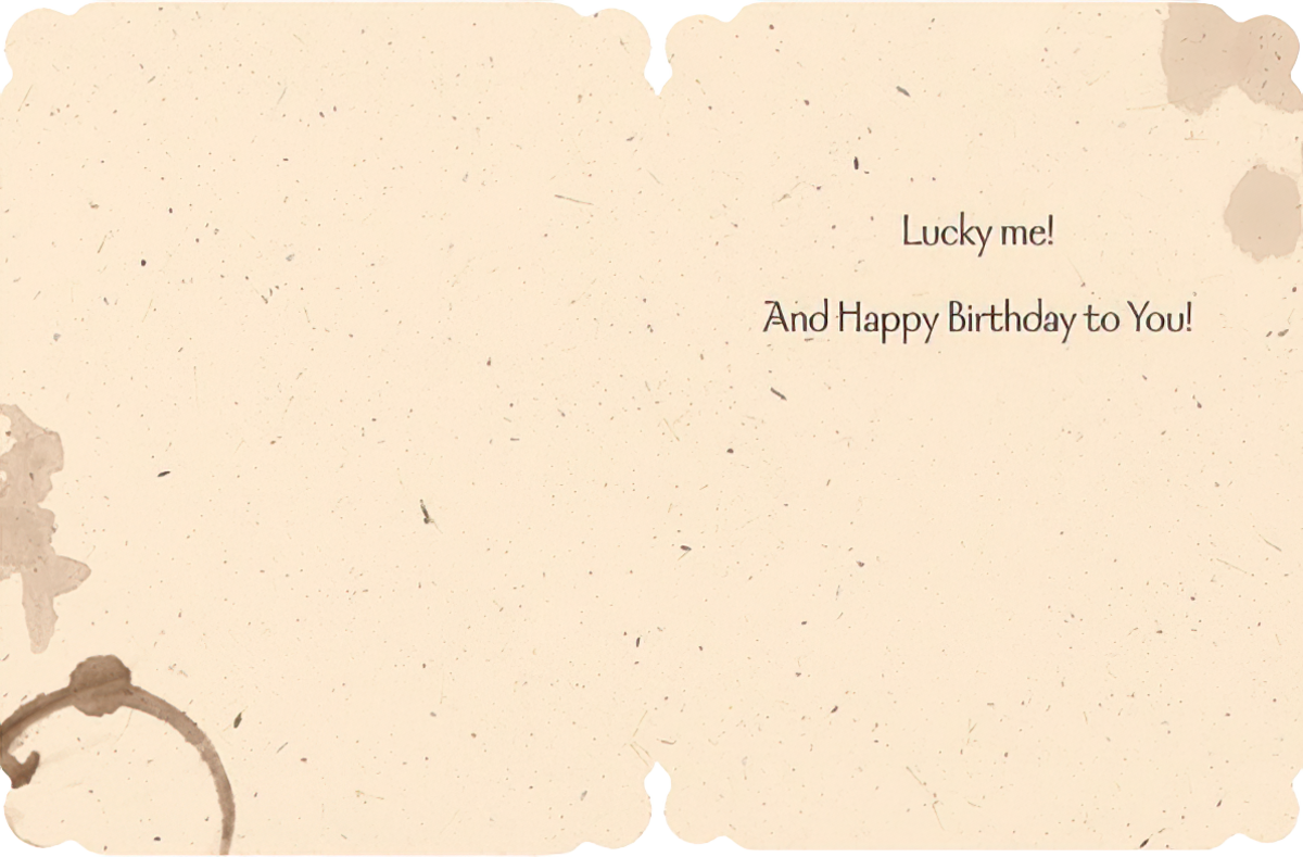 Inside of a rustic-themed birthday greeting card with coffee stain designs. Text says: 'Lucky me! And Happy Birthday to You!' showing space for a personal message.