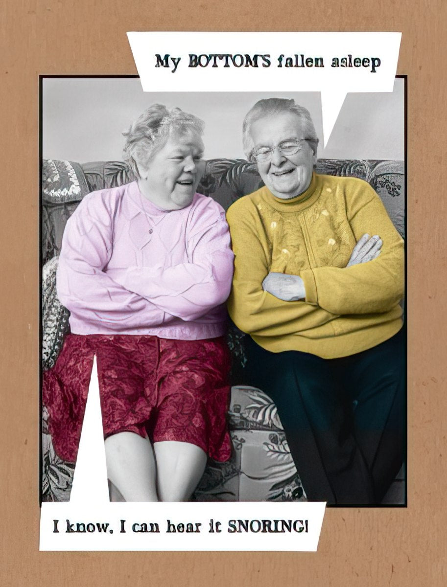 Funny greeting card front featuring two senior women laughing on a sofa, with speech bubbles showing a humorous exchange about a sleeping 'bottom' and snoring. Perfect for a friend's special day.