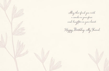 Inside of a birthday greeting card with a message about finding a smile and laughter, with Happy Birthday, My Friend.