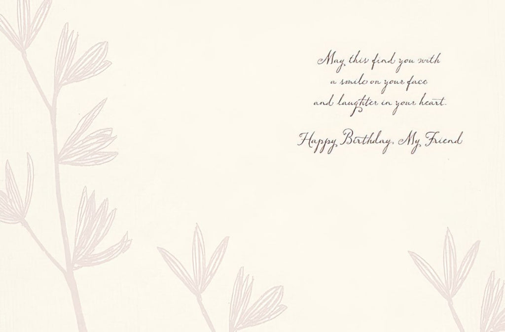 Inside of a thoughtful greeting card with a delicate floral design and a warm message: 'May this find you with a smile on your face and laughter in your heart. Happy Birthday, My Friend.' Ideal for celebrating a cherished female friend.