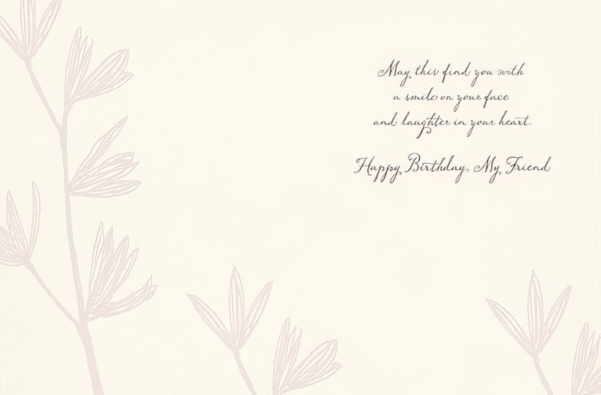 Inside of a thoughtful greeting card with a delicate floral design and a warm message: 'May this find you with a smile on your face and laughter in your heart. Happy Birthday, My Friend.' Ideal for celebrating a cherished female friend.