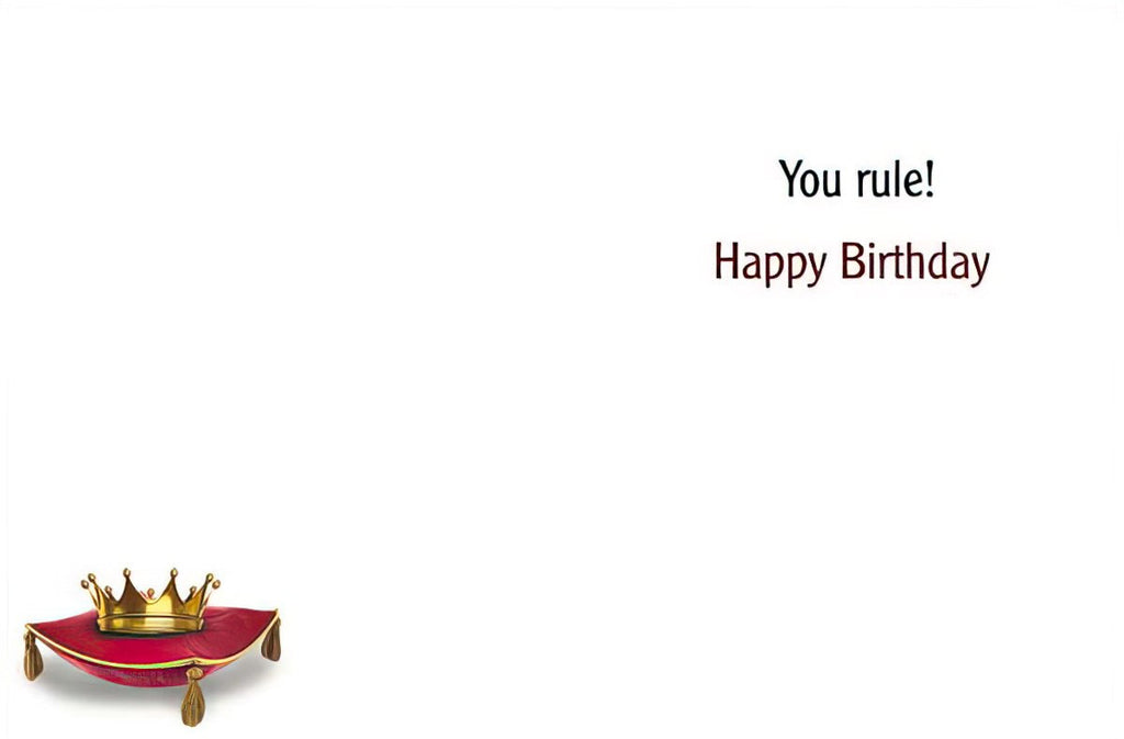 Inside of a funny queen-themed greeting card showing the message 'You rule! Happy Birthday' with a golden crown on a red cushion.