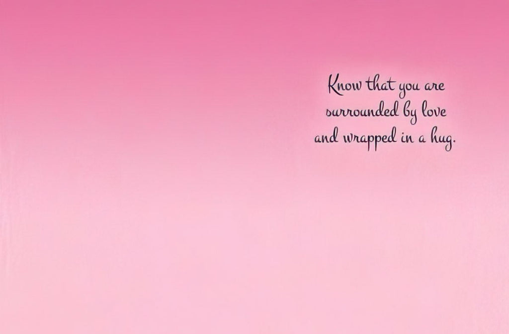 Inside of the encouragement greeting card with a soft pink gradient background and black cursive text on the right side reading "Know that you are surrounded by love and wrapped in a hug.".
