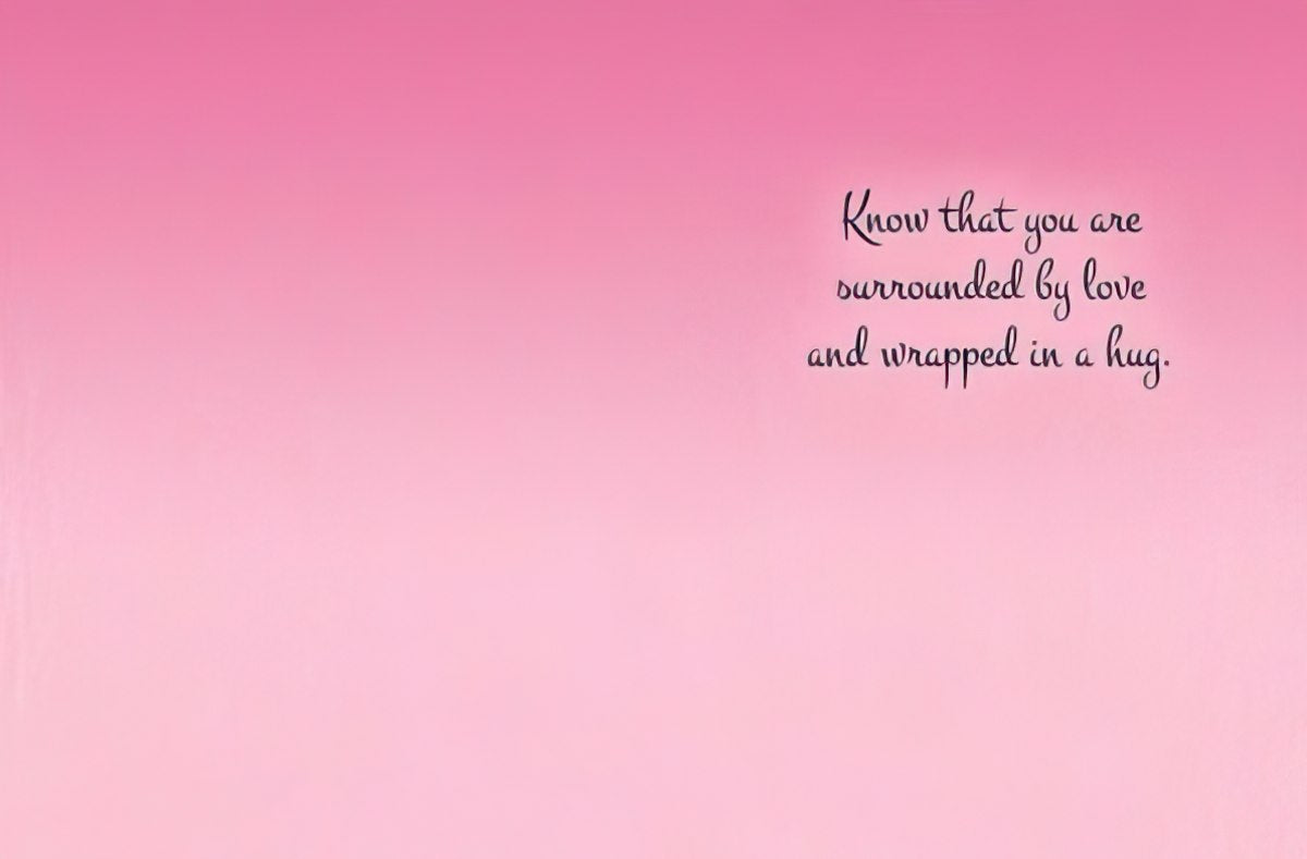 Inside of the encouragement greeting card with a soft pink gradient background and black cursive text on the right side reading "Know that you are surrounded by love and wrapped in a hug.".