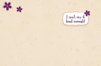 Inside of a thank you card with 'I can't say it loud enough!' text and purple flowers on a light, textured background.