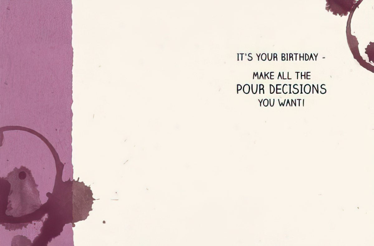 Inside of a funny birthday card, displaying the witty message 'IT'S YOUR BIRTHDAY - MAKE ALL THE POUR DECISIONS YOU WANT!', against a white background with purple wine stain accents.