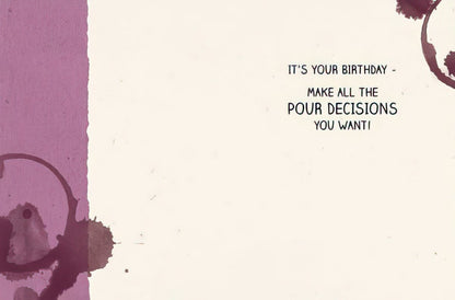 Inside of a humorous birthday greeting card with wine stain graphics and the message 'IT'S YOUR BIRTHDAY - MAKE ALL THE POUR DECISIONS YOU WANT!'