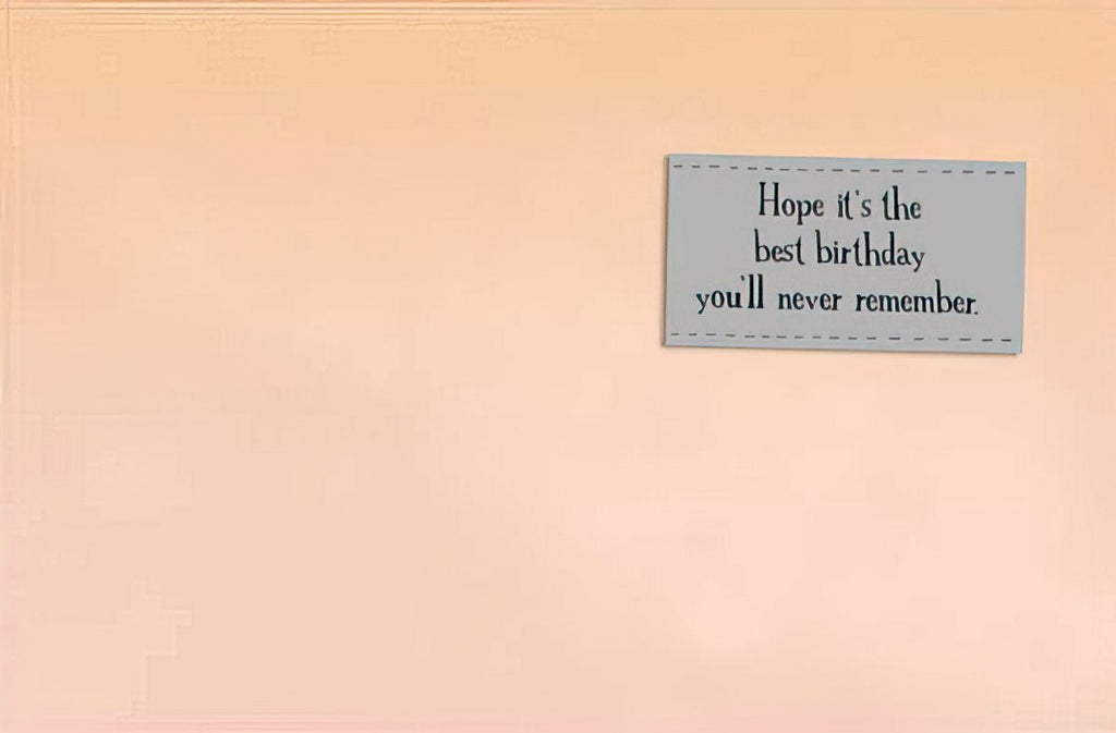 Inside a humorous birthday greeting card displaying the message 'Hope it's the best birthday you'll never remember' on a light peach background.