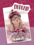 Cute blonde child in a pink feather boa, large hat, and round glasses blowing a kiss, with 'MUUVAH!' text on a decorative greeting card front.