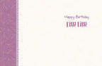 Inside of a cream-colored birthday greeting card featuring 'Happy Birthday Kiss! Kiss!' text in purple, with a decorative purple patterned border.