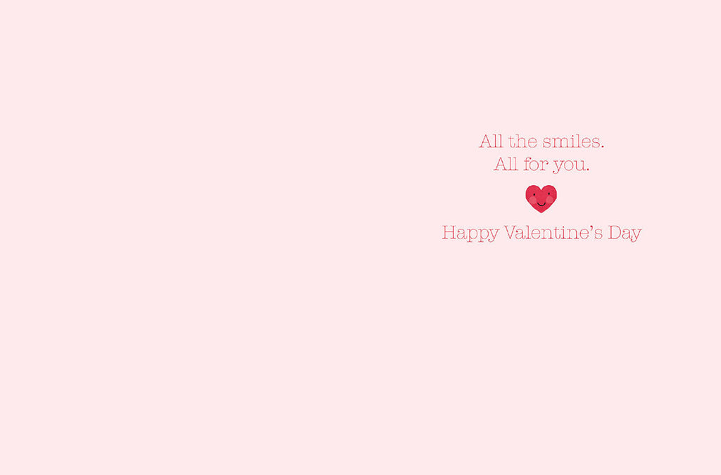 Inside of a sweet Valentine's Day greeting card with a light pink background and text 'All the smiles. All for you. Happy Valentine's Day' perfect for loved ones.