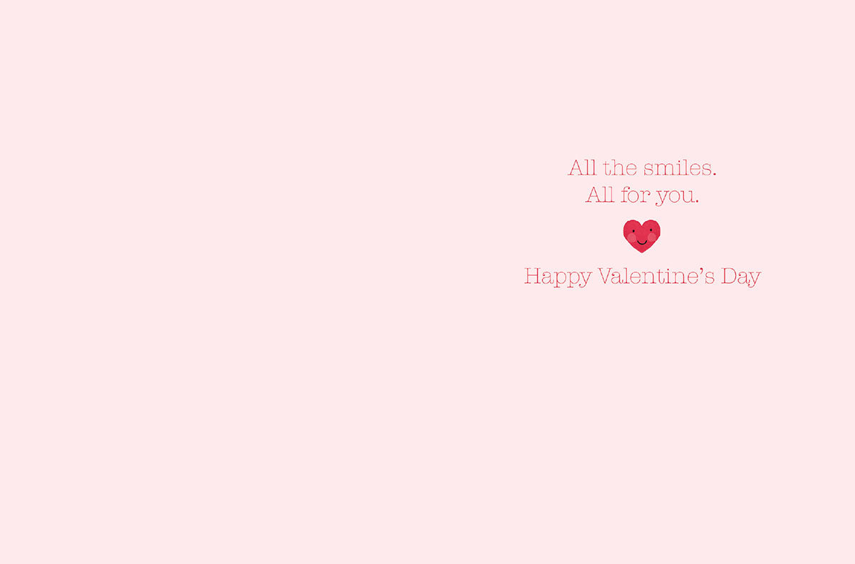 Inside of a sweet Valentine's Day greeting card with a light pink background and text 'All the smiles. All for you. Happy Valentine's Day' perfect for loved ones.