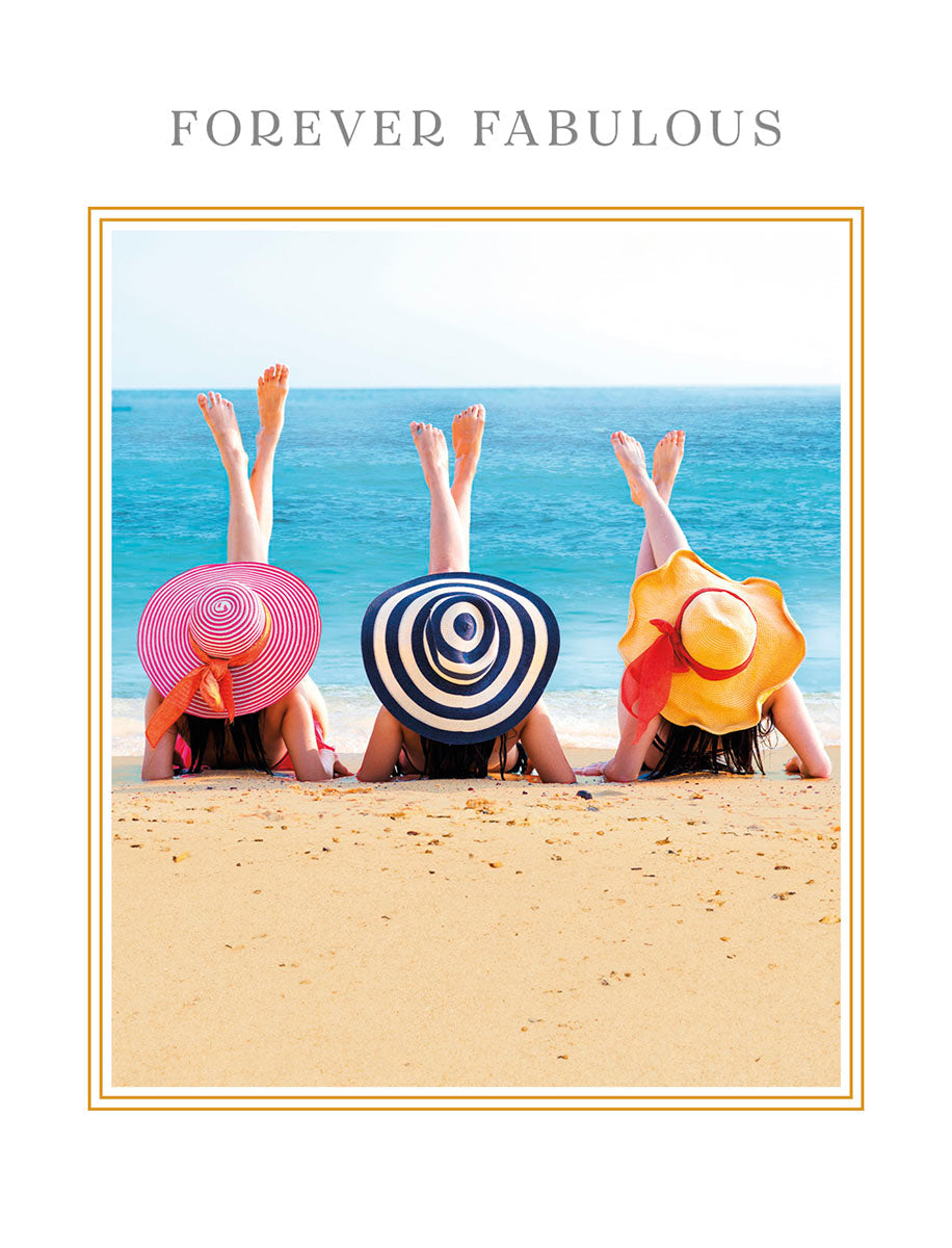 Greeting card featuring three women in colorful sun hats, upside down with legs in the air on a sandy beach, with text 'FOREVER FABULOUS'. Perfect lighthearted birthday card for a friend.
