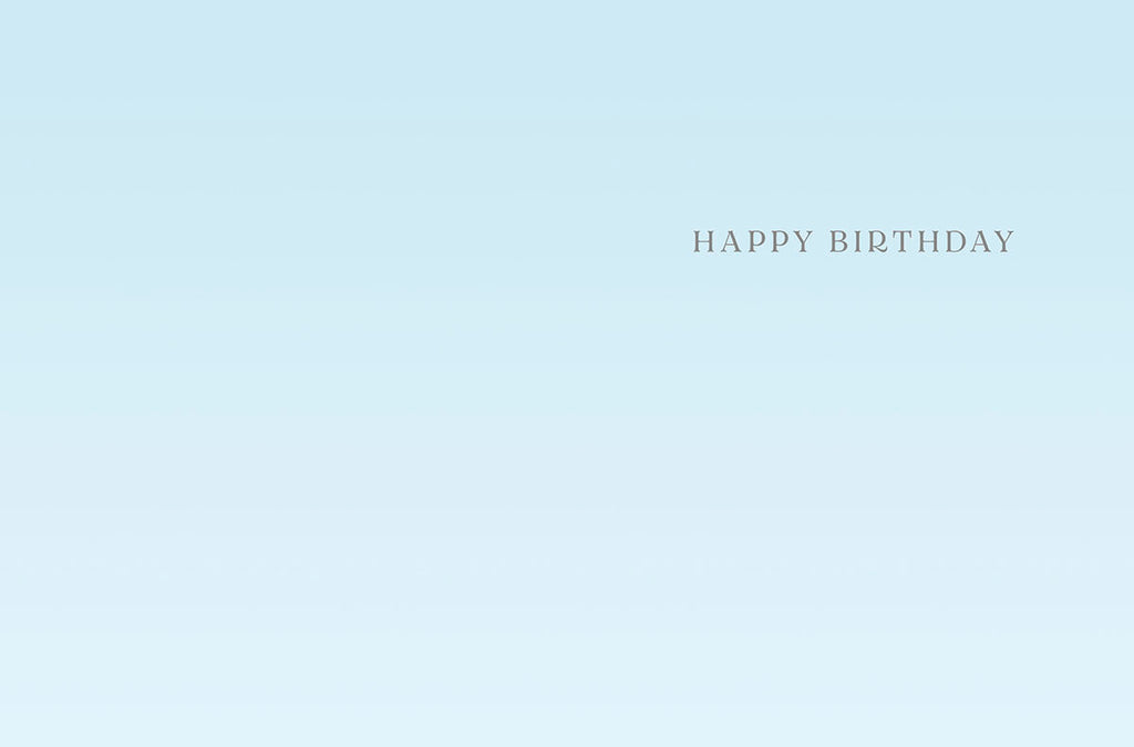Inside of a light blue greeting card with elegant 'HAPPY BIRTHDAY' text, offering space for a personalized message.