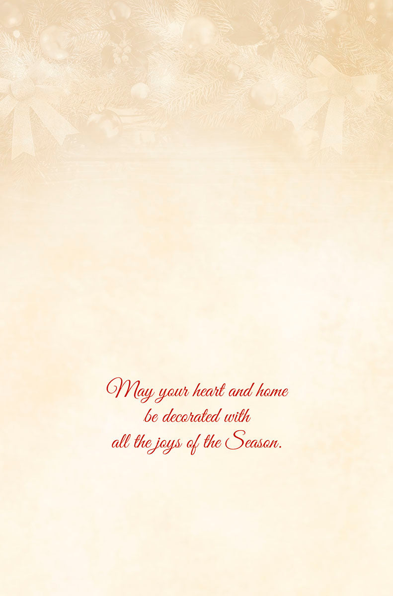 Inside of a warm, inviting holiday greeting card, with a subtle golden background showing hints of festive decorations. Red script text wishes 'May your heart and home be decorated with all the joys of the Season.'