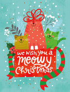 Cute cat holiday card front featuring three festive cartoon cats (red, green, gold) with a 'meowy yuletide' message, snowflakes, and holly on a blue background. Perfect for sending warm season's greetings.