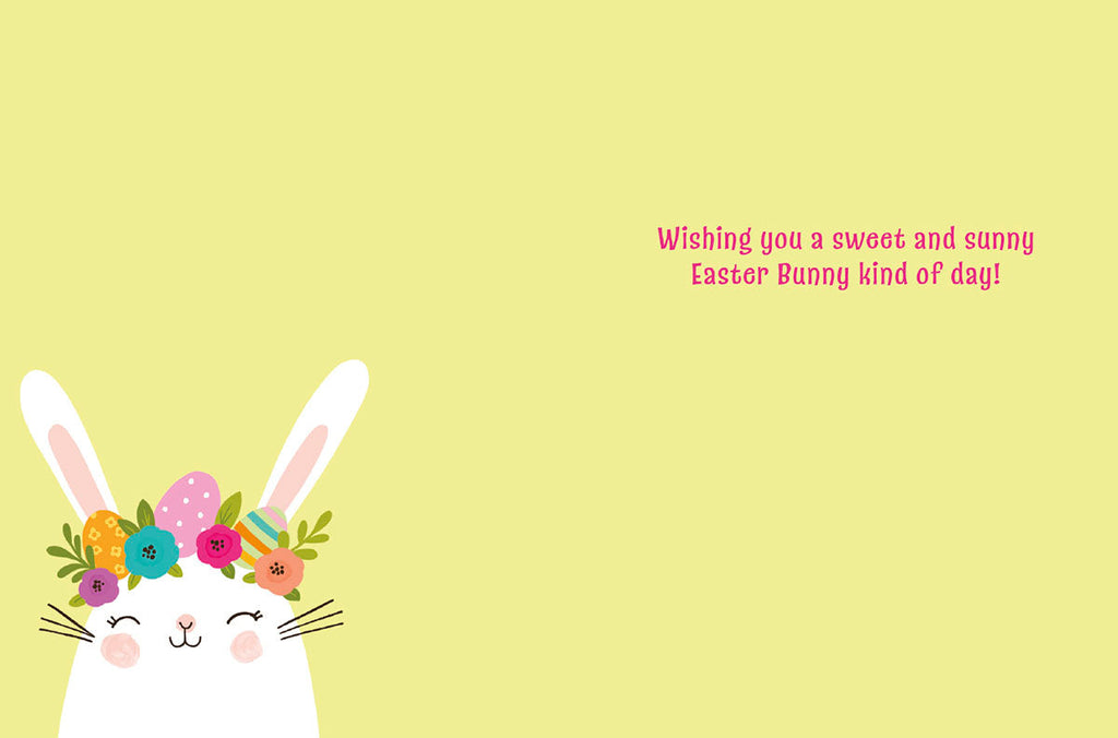 Inside view of a sweet Easter greeting card with a cute white bunny wearing a flower crown in the bottom left corner. The card's message, 'Wishing you a sweet and sunny Easter Bunny kind of day!', is written in pink text on a soft yellow background. Perfect for sending cheerful spring wishes.