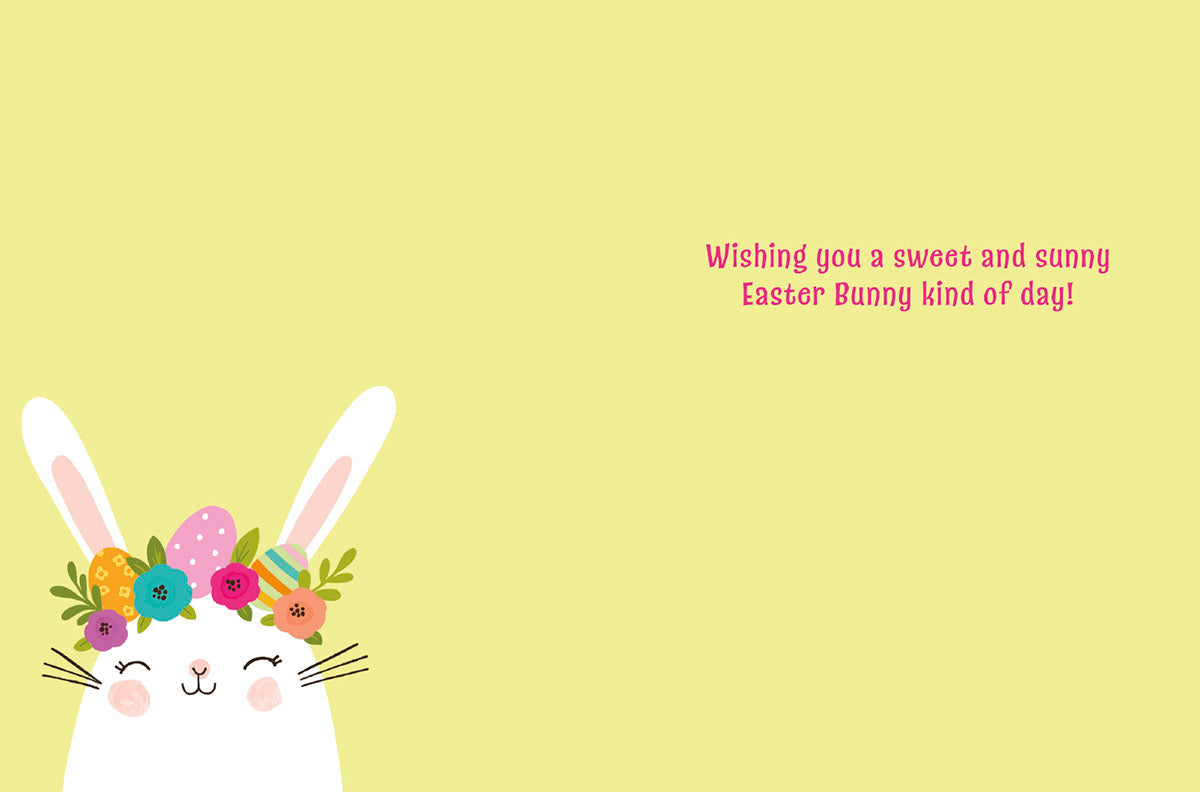 Inside view of a sweet Easter greeting card with a cute white bunny wearing a flower crown in the bottom left corner. The card's message, 'Wishing you a sweet and sunny Easter Bunny kind of day!', is written in pink text on a soft yellow background. Perfect for sending cheerful spring wishes.
