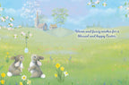 Inside of a greeting card showing two cute bunnies in a spring field with a church, displaying the message 'Warm and fuzzy wishes for a blessed and happy Easter,' ideal for religious well wishes and seasonal greetings.