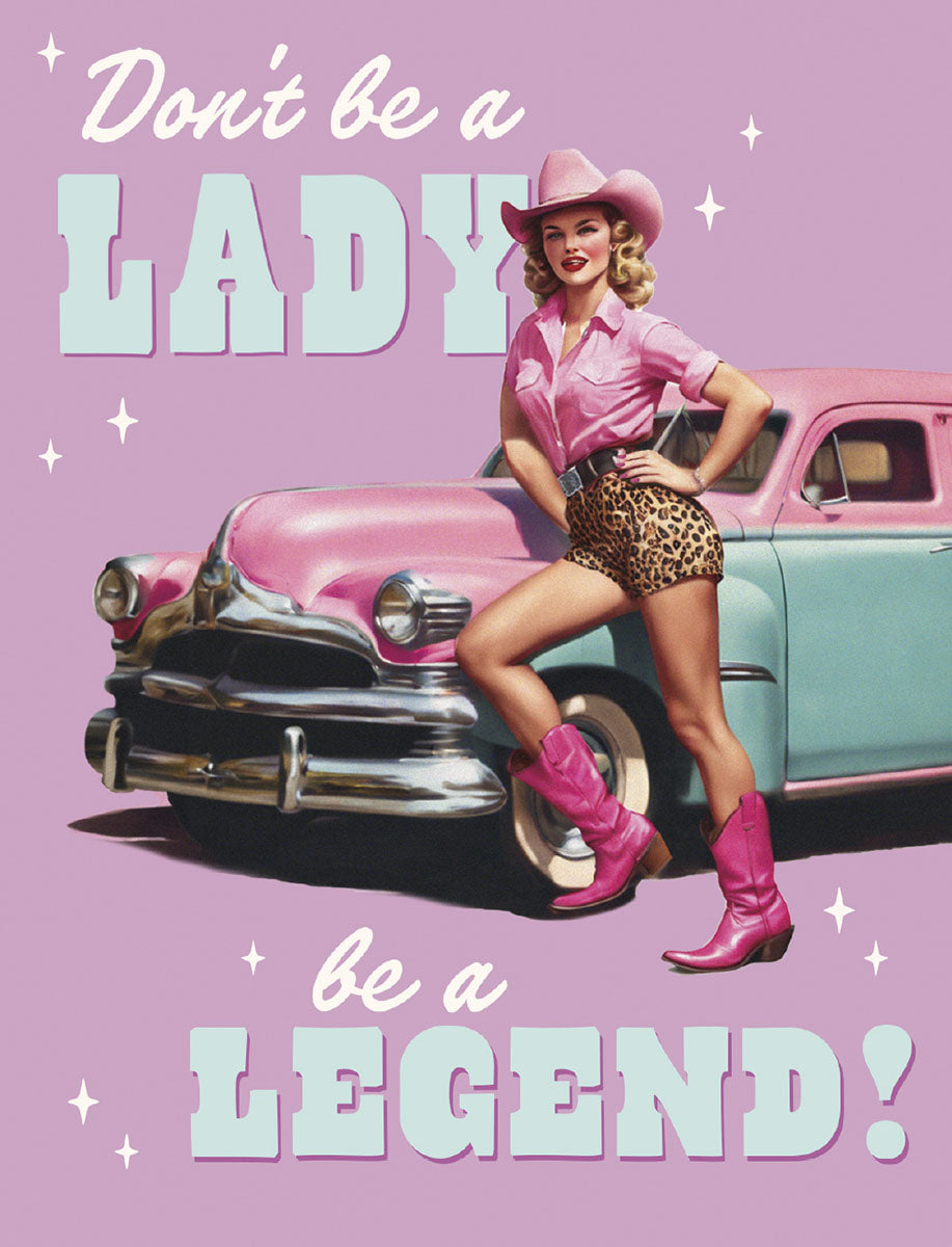 Sassy birthday card cover featuring a retro blonde woman in a pink cowboy hat, pink boots, and leopard print shorts, confidently posing by a vintage pink and teal car. Text reads: "Don't be a LADY, be a LEGEND!".