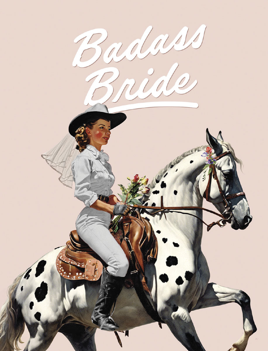 Vintage illustration of a confident cowgirl bride in a white shirt, pants, and hat with a veil, riding a white horse with black spots. The card features the text 'Badass Bride' in white script against a light pink background.