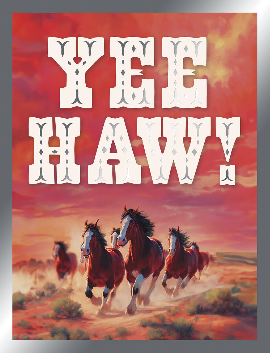 Front of a vibrant friendship greeting card featuring 'YEE HAW!' in bold, rustic white letters above a wild herd of brown and white horses galloping across a dusty, red-orange sunset desert landscape.