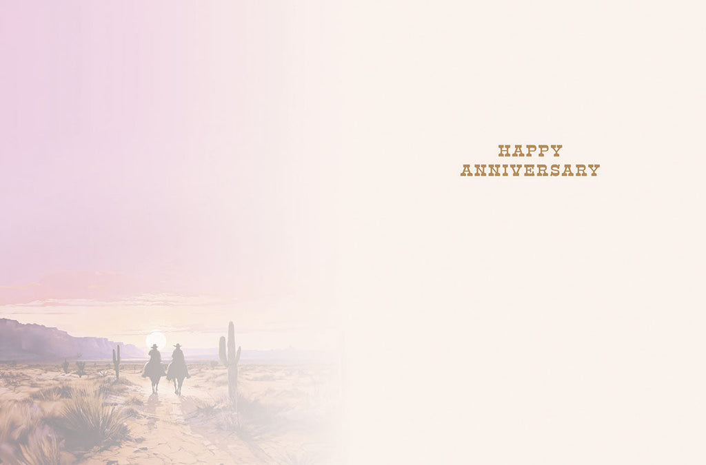 Inside of a romantic anniversary card with a subtle desert sunset background, showing faint distant riders, and the elegant text 'HAPPY ANNIVERSARY' with ample space for a personal message.