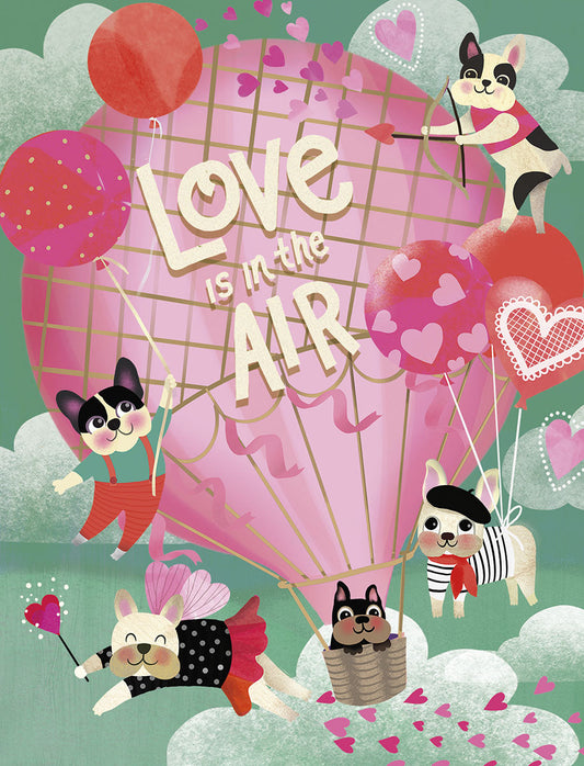 Front of Valentine's Day card with cute dogs, hot air balloon, and 'Love is in the AIR' text. Pink and red hearts fill the sky.