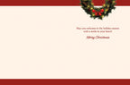 Inside of a holiday greeting card with a simple, elegant message in red script: 'May you welcome in the holiday season with a smile in your heart! Merry Christmas.' A small festive green wreath with a red bow decorates the top right corner.