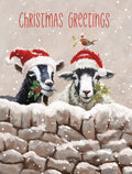Front of a cute winter greeting card featuring a black goat and white sheep wearing red Santa hats, peeking over a snowy stone wall. Both animals hold holly and mistletoe sprigs. A small robin with mistletoe perches on the sheep's hat. Gentle snow falls, creating a whimsical festive scene.