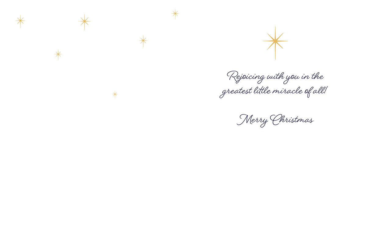 Inside view of a religious holiday greeting card featuring the message 'Rejoicing with you in the greatest little miracle of all! Merry Christmas' surrounded by golden stars.