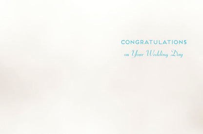 Inside of a wedding greeting card with blue text 'CONGRATULATIONS on Your Wedding Day' on a plain white background.