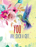 Front of a vibrant floral greeting card featuring a hummingbird amidst pink, teal, and yellow flowers with the heartfelt message 'YOU ARE SUCH A GIFT...' perfect for celebrating her special day.