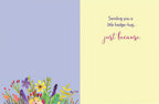 Inside of a friendly hedgehog greeting card displaying the message 'Sending you a little hedge-hug... just because.' with a vibrant floral border.