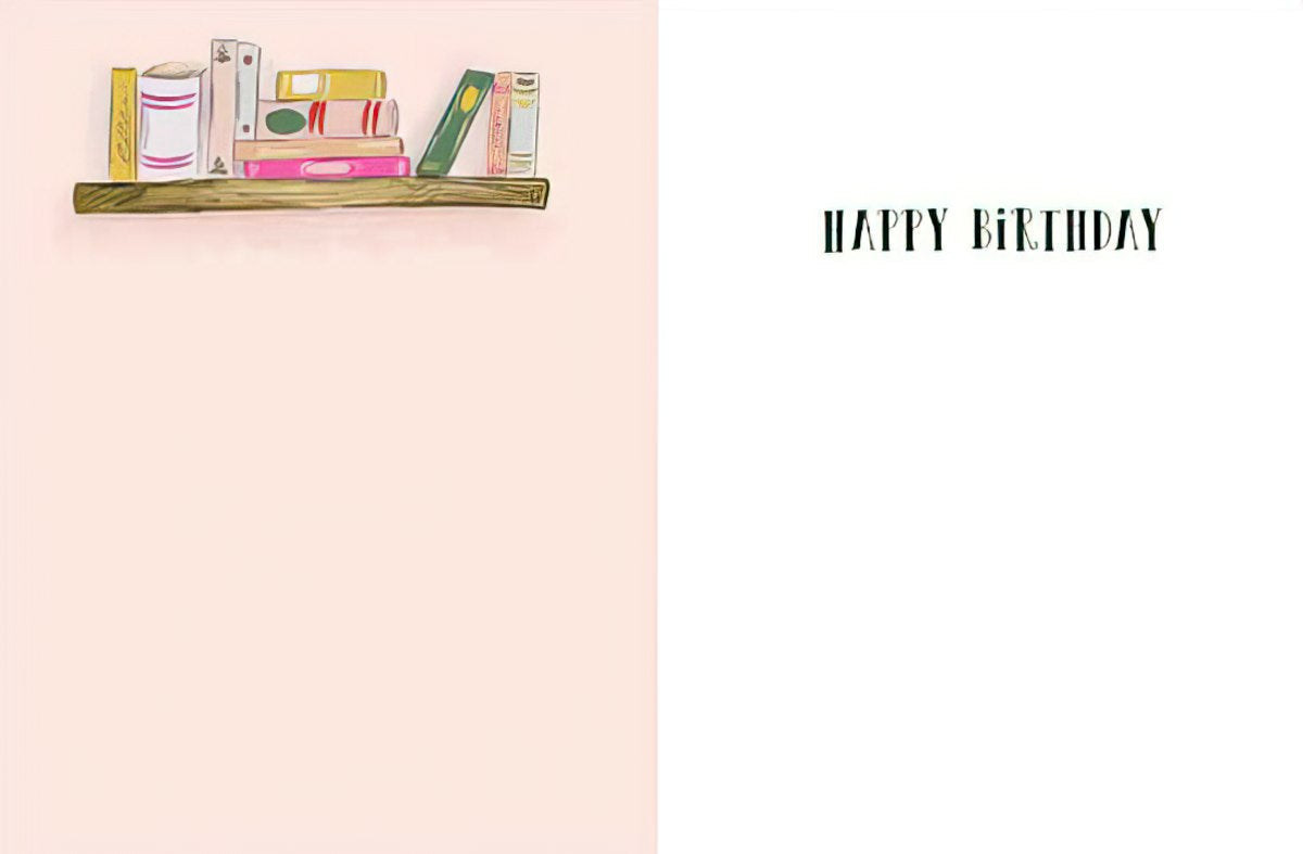 Inside view of a punny 'Literarily The Best' birthday card, showing the top part of a colorful bookshelf illustration on the left and the simple, celebratory message 'HAPPY BIRTHDAY' in dark green text on a clean white background on the right, ideal for a friend.