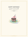 Greeting card front featuring a slice of decadent chocolate cake with pink frosting, a cherry, and a gold fork on a mint plate, framed by elegant gold trim. Text reads: 'HAPPY BIRTHDAY spoil yourself'.
