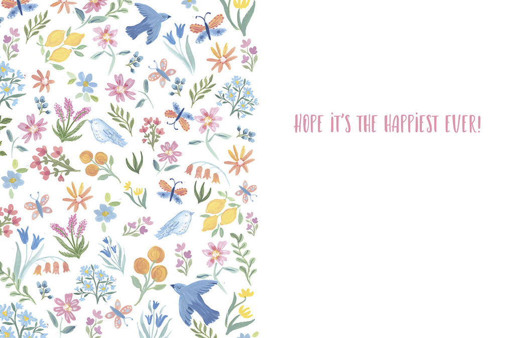 Open cute birthday card with a watercolor floral pattern on the left, including flowers, birds, and butterflies. The right side is blank with "HOPE IT'S THE HAPPIEST EVER!" text in pink.