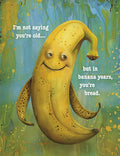 Humorous banana greeting card for men, featuring a smiling banana character and the funny phrase 'I'm not saying you're old... but in banana years, you're bread.' Perfect for friends celebrating their special day.