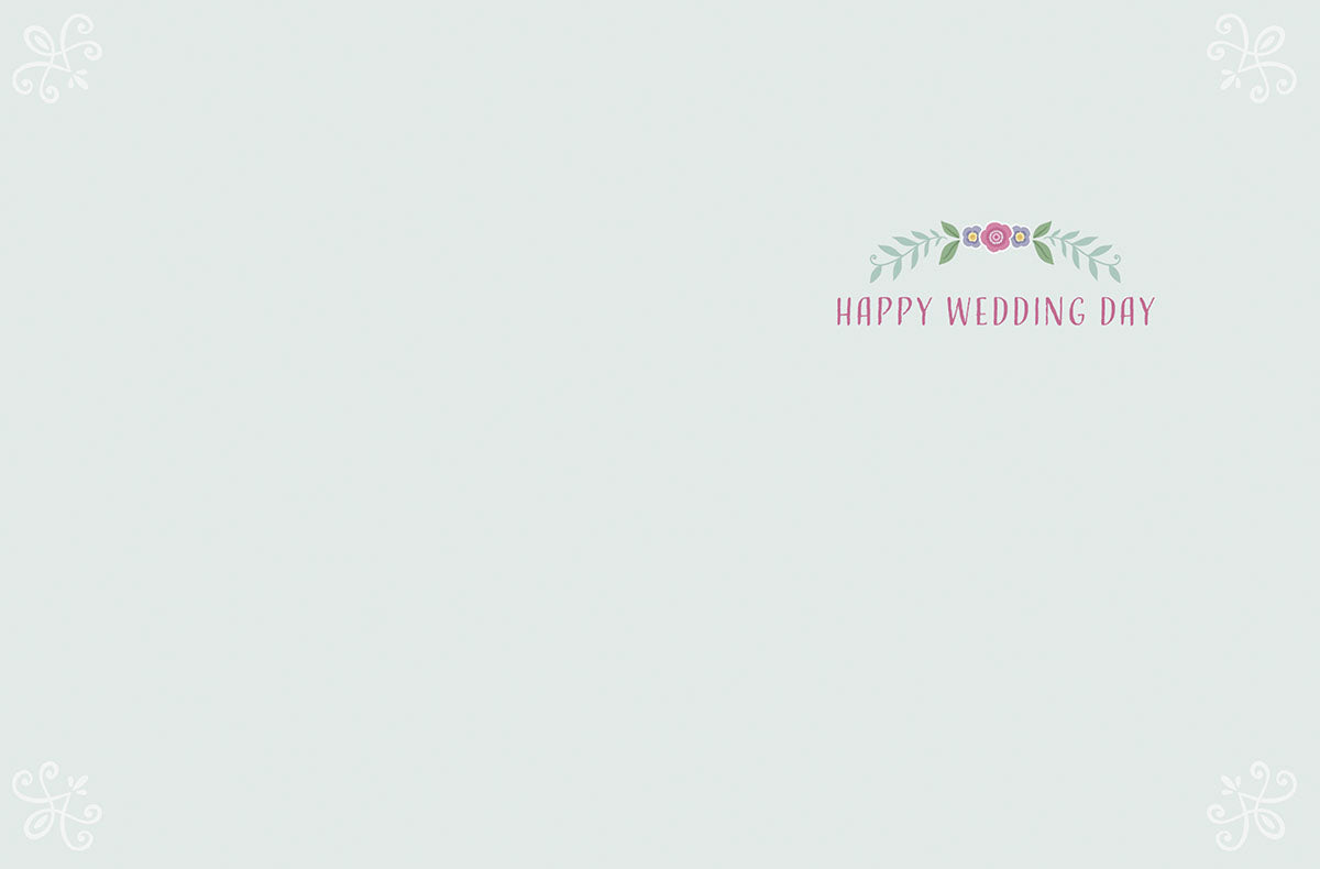 Inside of a romantic wedding card displaying 'Happy Wedding Day' in delicate pink lettering with a small floral cluster, against a light blue-grey background, offering ample space for a personalized message.