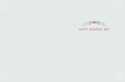 Inside of the wedding card with 'Happy Wedding Day' text and a small floral design on a light blue-green background.