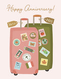 Happy anniversary greeting card with two travel suitcases, one pink 'Hers' and one green 'His', adorned with international destination stickers like Italy, Japan, Mexico, Florida, and Belize. Perfect for adventurous couples celebrating their love.