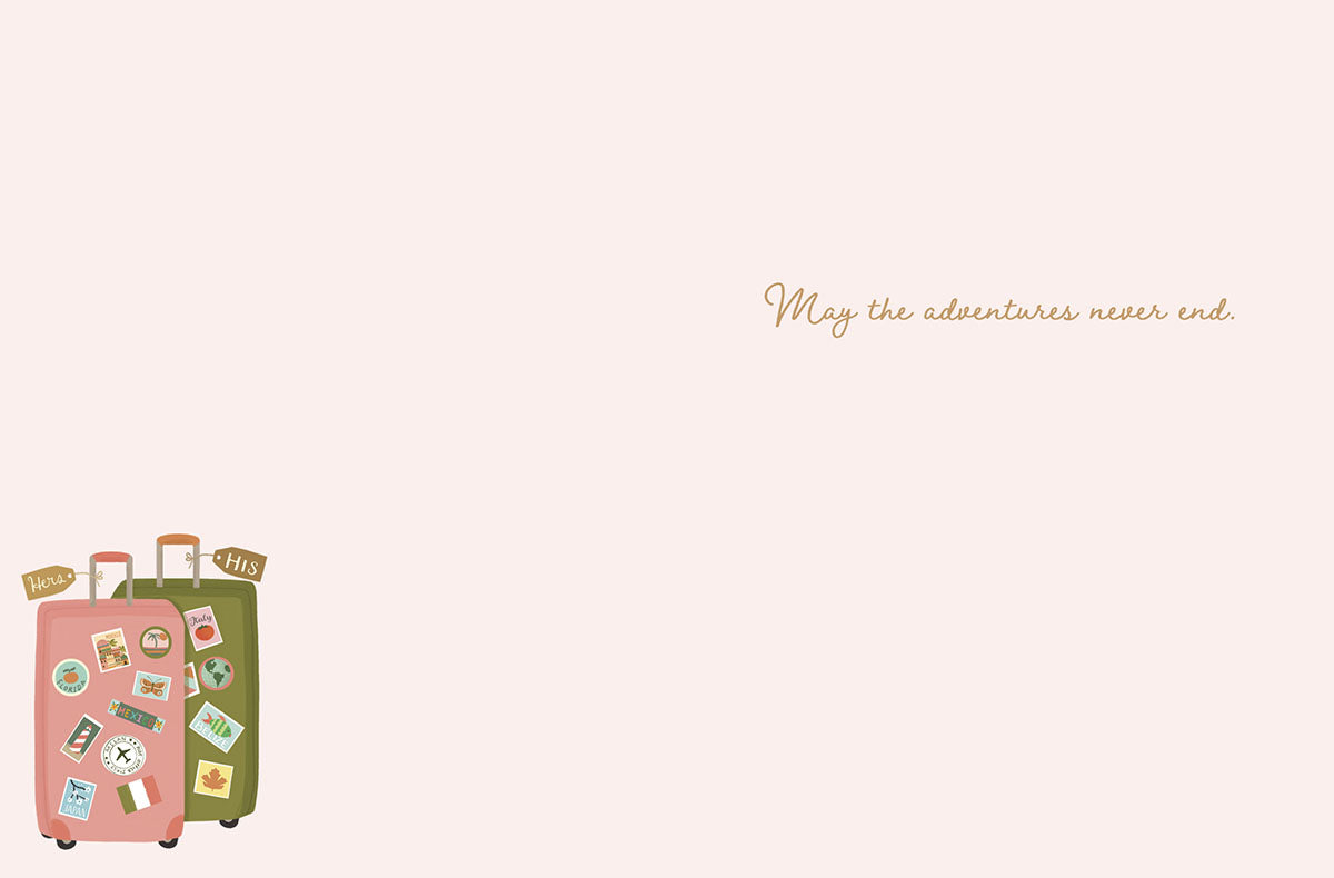 Inside view of a romantic anniversary card featuring the elegant message 'May the adventures never end.' accompanied by a small illustration of matching travel suitcases in the bottom corner.