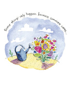 Front of a watercolor thank you card featuring a blue watering can nourishing a vibrant bouquet of multicolored flowers on a sandy landscape. Text reads: 'Some things only happen because someone cares...'