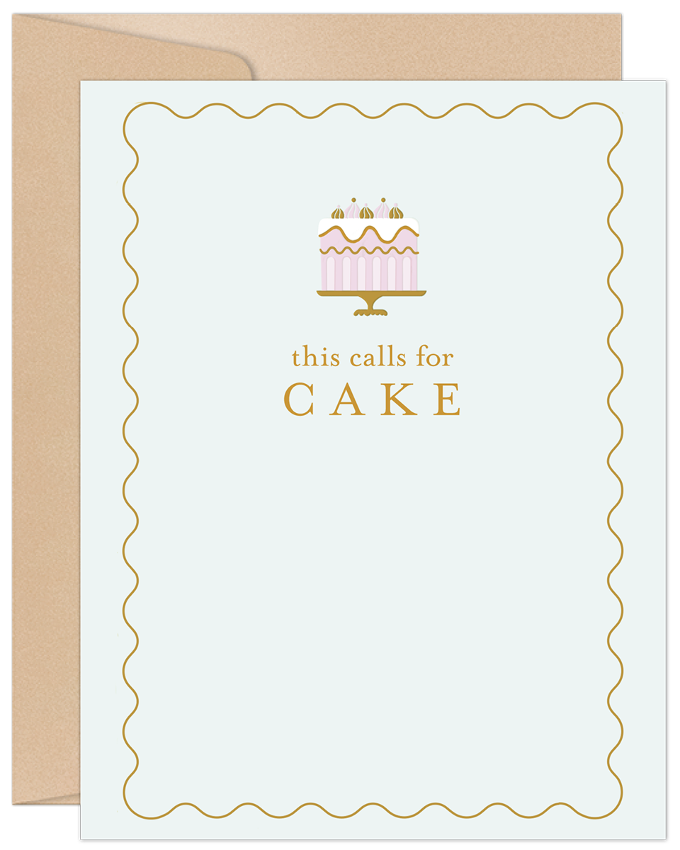 Elegant birthday greeting card featuring a pink and gold cake illustration with text 'this calls for CAKE' on a light blue background with a gold wavy border, accompanied by a kraft envelope.