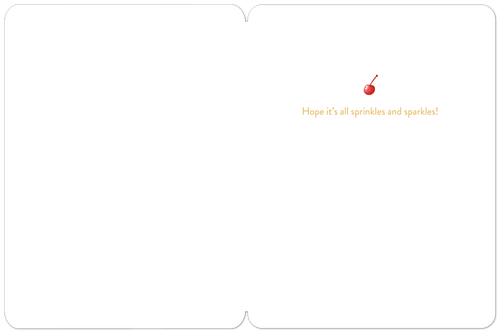 Inside view of a fun celebration card, revealing a clean white interior with a small cherry illustration and the heartfelt message 'Hope it's all sprinkles and sparkles!' for a joyful wish.